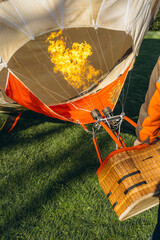  A man inflates a balloon at a balloon festival