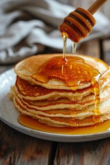 Delicious breakfast, pancakes with butter and sweet syrup.