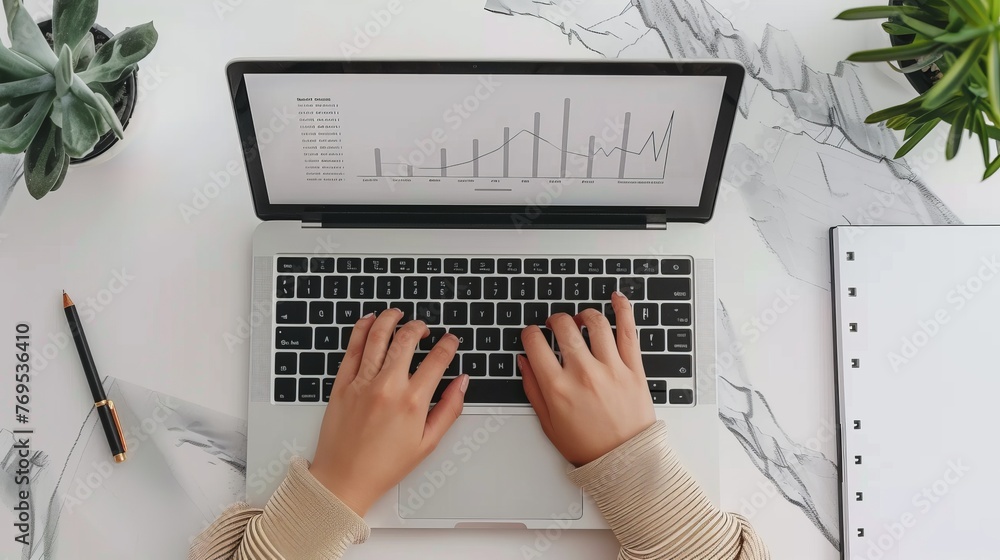 Fototapete the top view of a laptop with financial charts at the screen is a mockup for an advertisement, an an