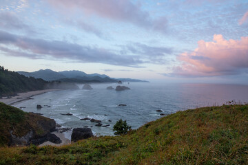 Beautiful colorful sunrise above famous Cannon Beach and Haystack Rock in Oregon, captured from Ecola Stat Park