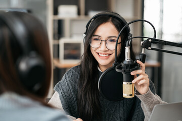 Professional Female Interviewer in studio recording livestudio with Guest - podcast & communication.