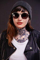 Confident, woman and punk fashion in studio for trendy rocker style with sunglasses. Bold, female...
