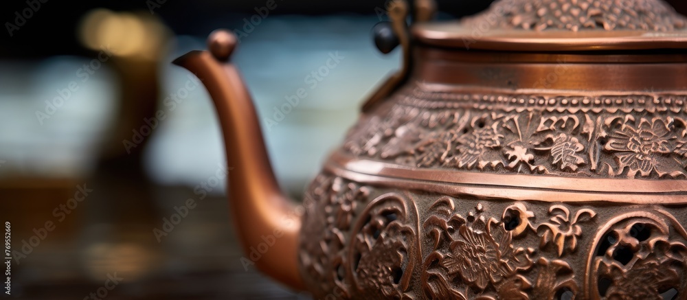 Poster an artistic copper teapot sits on a wooden table, creating a beautiful pattern with its metal surfac