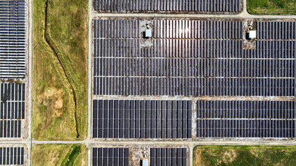 The aerial view Alternative clean energy while the solar panel, solar -with wind turbines generating electricity farm field construction renewable energy a field background