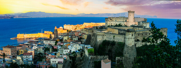 Italy travel. Gaeta - beautiful coastal town in Lazio region. cityscape with medieval castle and the sea over sunset - obrazy, fototapety, plakaty