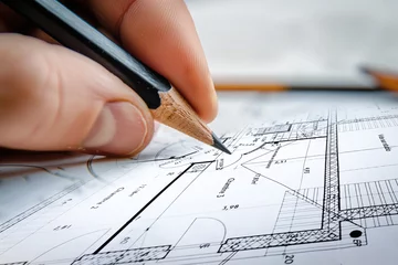 Foto auf Acrylglas Main d'un architecte qui dessine un plan technique d'une maisdon avec un crayon © Chlorophylle