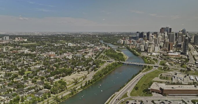 Calgary AB Canada Aerial v5 drone flyover West Village across Bow river towards Westmount capturing Mewata Bridge and riverfront downtown cityscape at daytime - Shot with Mavic 3 Pro Cine - July 2023