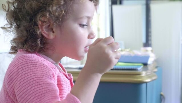 Indoor Bubble Bonanza: Little Girl's Playful Glee