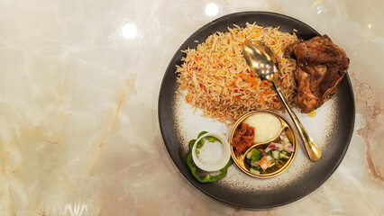 Arabic food kebuli rice (nasi kebuli) on the table with empty space beside it