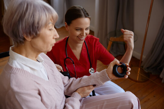 Senior woman in wheelchair working with her occupational therapist