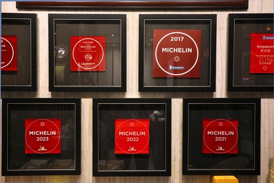 SINGAPORE CITY, SINGAPORE - MARCH 11, 2024: Multiple Michelin Star awards displayed inside Putien restaurant in Singapore City.