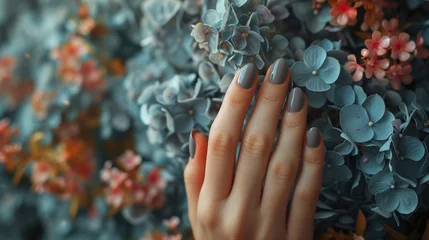 Fototapeten Beautifully manicured woman's hand with a colorful floral background, elegant and stylish nail art design concept © VICHIZH