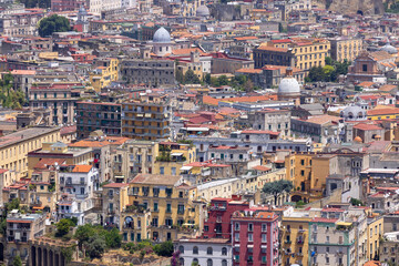 Fototapeta na wymiar Naples, Italy - June 27, 2021: General aerial view of the city, dense buildings, progressive urbanization of the city. Colorful facades of building