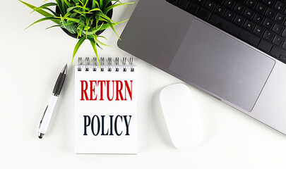RETURN POLICY text on notebook with laptop, mouse and pen - obrazy, fototapety, plakaty