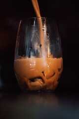 pouring espresso freddo in a glass