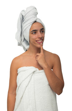 young woman, wrapped in a towel around her chest and head,  looking to the right with a contemplative expression, placing a finger on her lips in a thoughtful pose after a shower on empty background