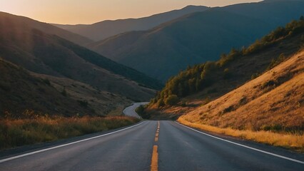 Asphalt road in mountains at sunset. Landscape of mountains.
