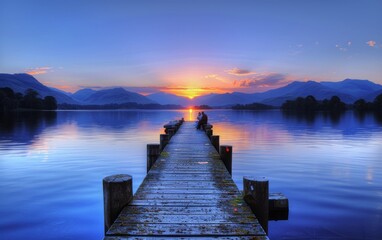 wooden jetty extending into the serene waters of the Lake District, with distant mountains - obrazy, fototapety, plakaty