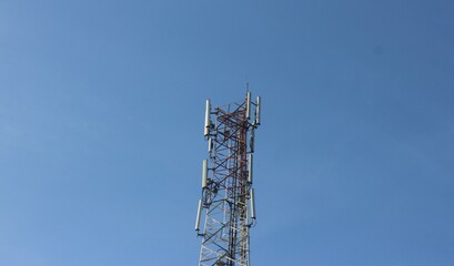 Signal tower on blue sky background. Telecommunication tower