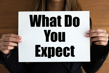 What do you expect? Woman with white page, black letters. Requirements, experience, job interview.