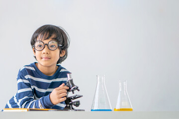 Education and smart children development concept. Little child boy performing science experiments...