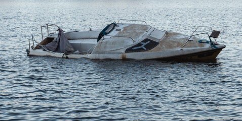 abandoned small sailing boat at anchor 