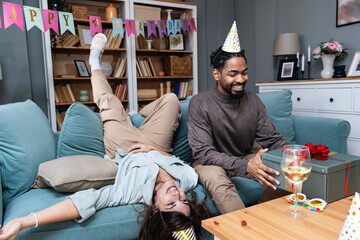 Crazy birthday party. Young couple celebrating birthday in their apartment alone having fun and joy...