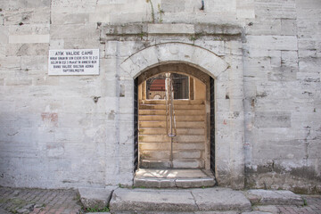 Fototapeta na wymiar Atik valide sultan mosque located in the district of Üsküdar in Istanbul. Entrance gate to the garden