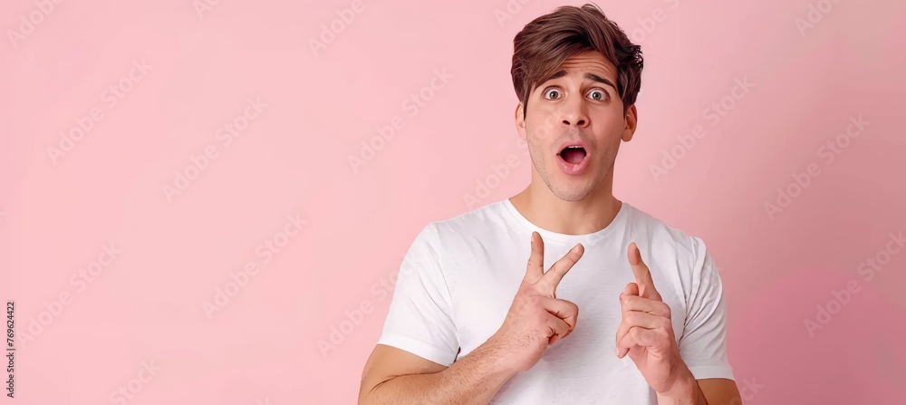 Poster excited man pointing on soft colored backdrop with ample space for text placement