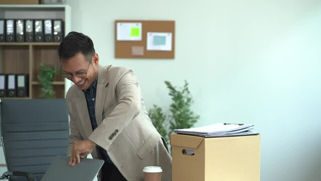 Successful businessman, excited young man packing up in office, job promotion concept, happy working.
