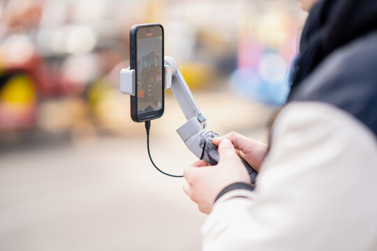 Smartphone gimbal for stable filming with microphone attached. Essential tool for any marketer right now
