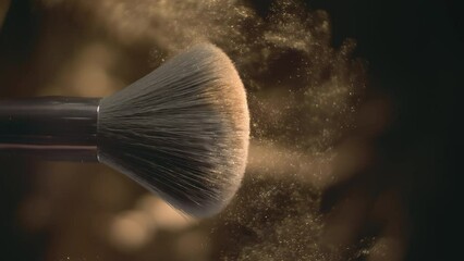 Makeup brush and golden face powder shake at 1000 fps. Elegant luxury make up cosmetic macro abstract background in super slow motion. Beauty make-up glitter flying. High speed close up vertical video - Powered by Adobe