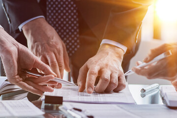 men close-up, looking in a folder with documents