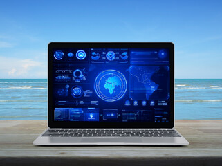 Laptop computer with digital world map with data charts and stats screen on wooden table over tropical sea and blue sky, Futuristic user interface technology online concept