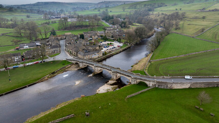 Aerial View of Burnsall bridge. One of the most beautiful villages in Wharfedale, Burnsall lies on a bend of the River Wharfe surrounded by a spectacular circle of fells. 