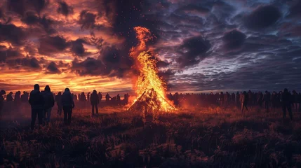 Foto op Aluminium Valborg bonfire celebration in Sweden. Silhouettes of people standing around a bonfire. © stefanholm