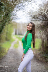 Young Woman in Green Top and White Pants