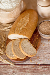 sliced bread with bran. bread with bran and the ingredients from which it is made. flour, bran and fresh bread.
