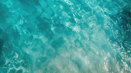 A tranquil image showing the rippling surface of clear turquoise water under sunlight.