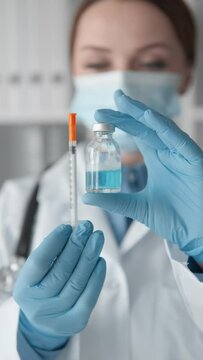 A medical professional preparing to administer an injection, illustrating the scientific and technological advancement in the medical field, demonstrating safety and care during medical practice.