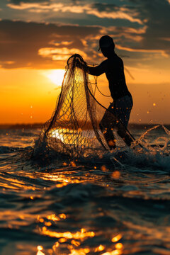 Silhouette of a fisherman casting a fishing net into the sea