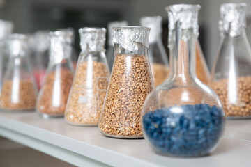 Samples of  encrustied and processed grains in a glass test tubes in agrochemistry lab. - 769670607