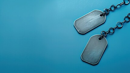 Two blank dog tags on a chain against blue background.