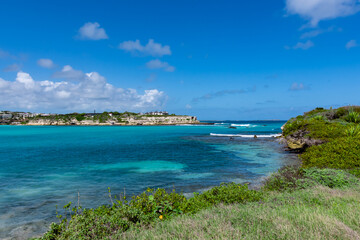 Looking out over a bay of turquoise waters on the island of Antigua in the Caribbean