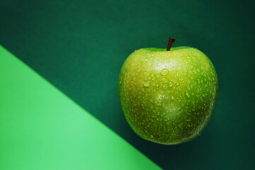 Ripe green apple on green background
