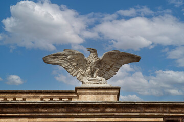 Catania, Sicily, Italy - April 30, 2023: Detail of decorative facade of baroque Teatro Massimo Bellini located in Piazza Vincenzo Bellini. Statue of great eagle on the top of building