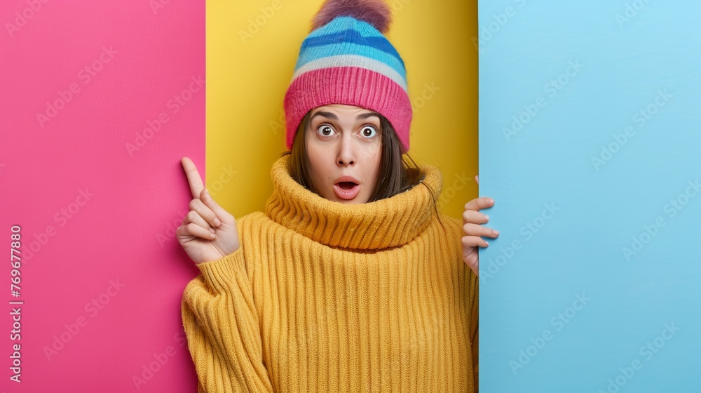 Poster energetic girl pointing on soft hued backdrop with generous area for adding text