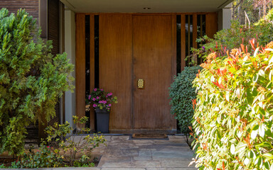 A contemporary design house entrance corridor in the garden and a wooden door. Travel to Athens, Greece. - 769679089