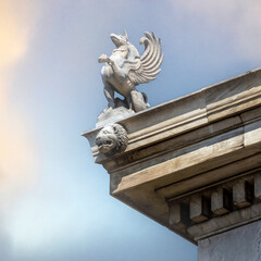 A Griffon statuette stands on the roof of Athens National University. These mythycal creatures were...