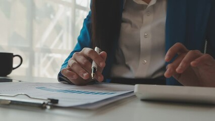 Business woman using calculator for do math finance on wooden desk in office and business working background, tax, accounting, statistics and analytic research concept - Powered by Adobe